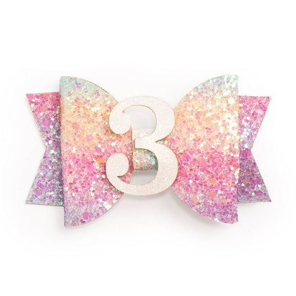 Every little girl needs the perfect hair clip to complete her look! The Pastel Rainbow #3 Clip is the perfect hair accessory for celebrating a 3rd birthday. Features: Pastel rainbow glitter bow with white glitter #3 Ribbon-covered alligator clip to grip the hair Glitter accents are “shed free” One size fits all Pair this hair clip with a matching Sweet Wink tutu and shirt for a complete head-to-toe outfit!