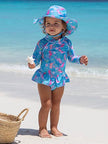 The UPF 50+ Alissa Infant Ruffle Rash Guard combines the effectiveness of a long sleeve rash guard and a one-piece swimsuit, providing full coverage sun protection and comfort. It features a snap tape for easy diaper changes or potty visits as well as a back zipper for easy to get in and out of the swimsuit. Our vibrant, fade-resistant quick-dry prints are made from soft and comfortable fabric made from recycled plastic bottles! SUSTAINABLY MADE: We’re pioneers in the swimwear industry, expanding sustainabl