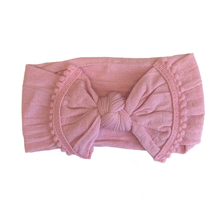 The softest baby headbands ever! Pair these adorable accessories with onesies, dresses, bloomers, and gowns for the cutest girl outfits. Color/Print: Rose Fabric: Nylon Sizing: Size 1 (0-12M) Fit: Stretchy Wash: Hand wash / Lay flat to dry Imported