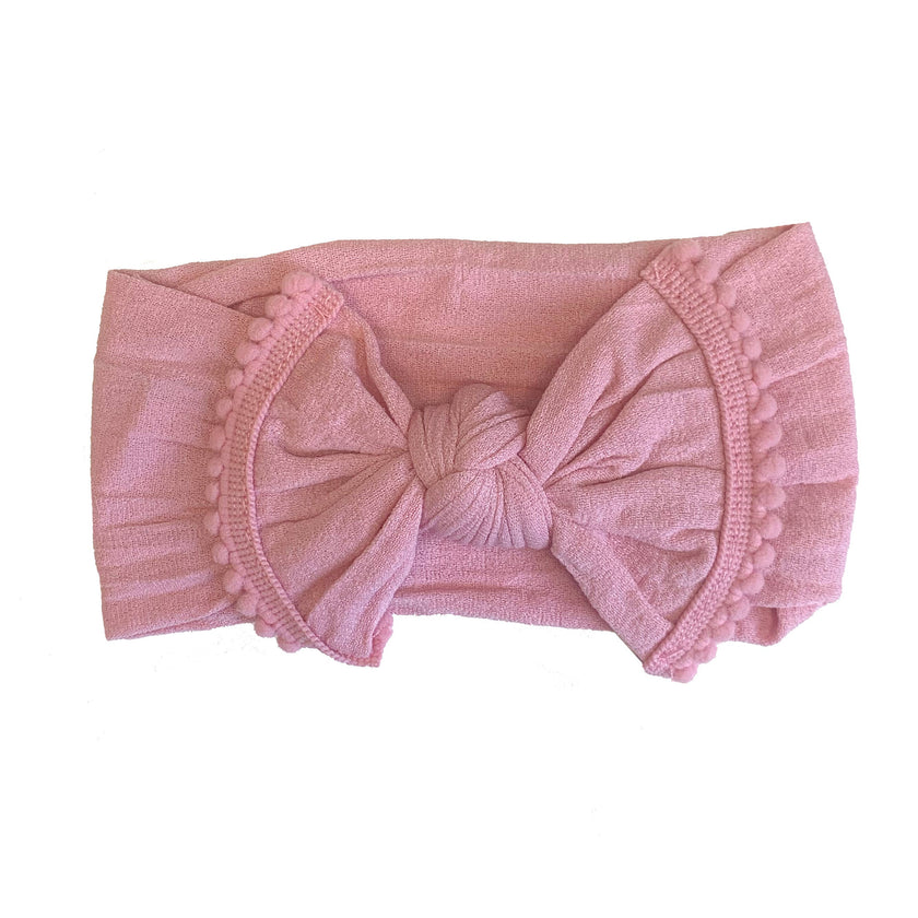 The softest baby headbands ever! Pair these adorable accessories with onesies, dresses, bloomers, and gowns for the cutest girl outfits. Color/Print: Rose Fabric: Nylon Sizing: Size 1 (0-12M) Fit: Stretchy Wash: Hand wash / Lay flat to dry Imported