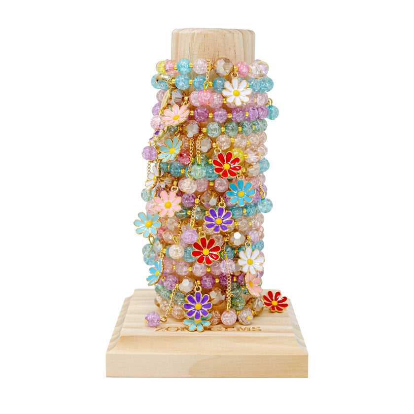 This stretchy bead bracelet is a charming accessory for girls who love daisies! The bracelet is made with small, colorful beads that stretch to fit comfortably around the wrist. The highlight of the bracelet is the adorable daisy charms and the hanging beads. - 24 assorted bracelets - Recommended for ages 3 + - Tower display included with purchase