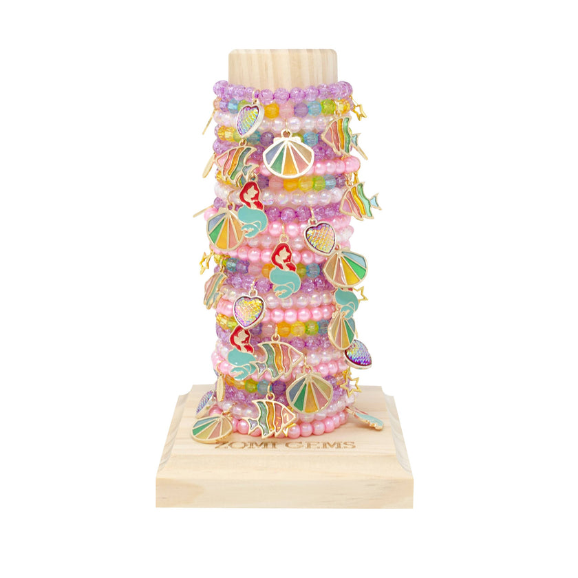 24 assorted stackable bead bracelets for kids. -Charms include Mermaid, Seashell, Fish and Scale Heart -Stretchy -Ages 2-16 -Display tower included ~Handmade with love~